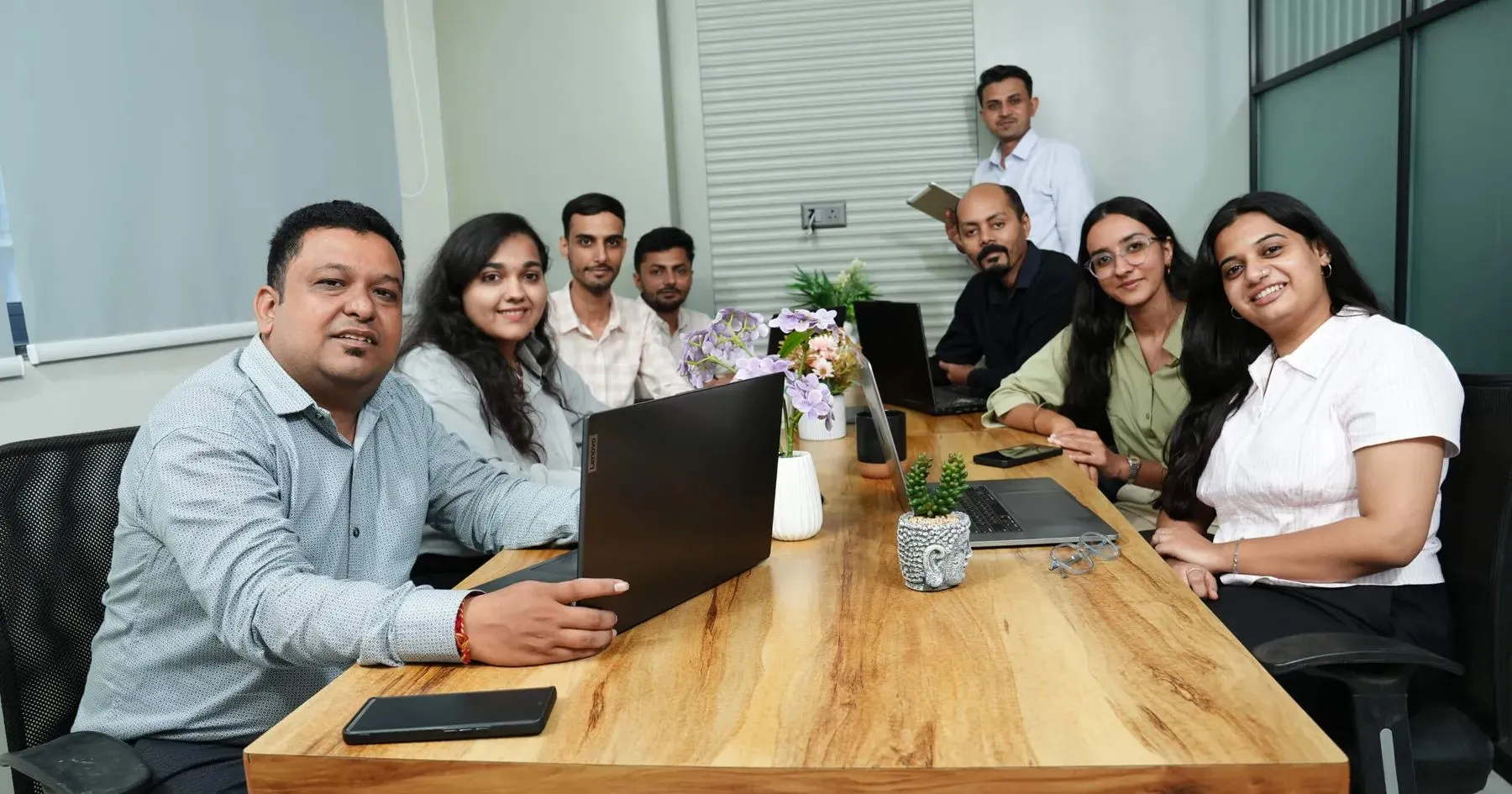 The team gathered around the table in the meeting room