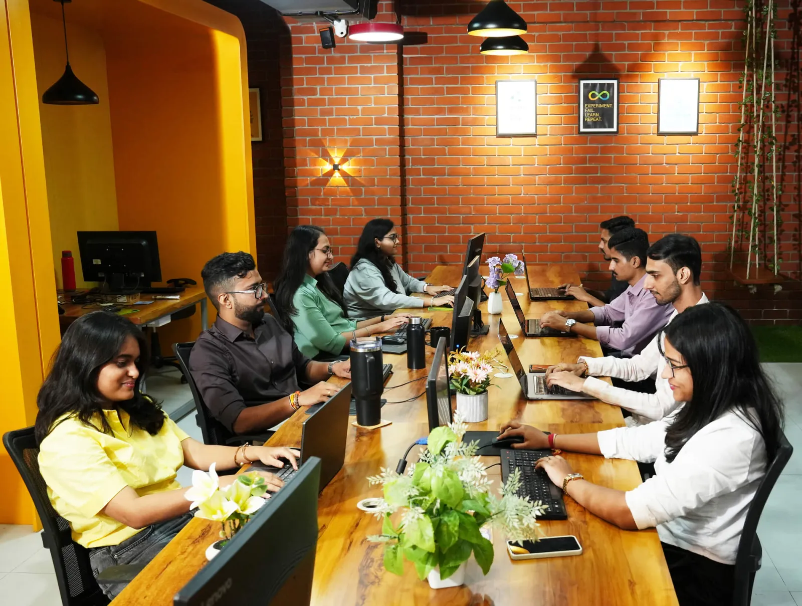 Wizard Infosys team working in a bright, open-plan office